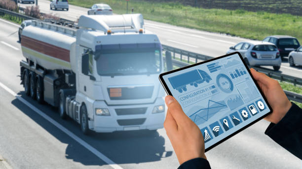 Manager with a digital tablet on the background of truck. Fleet management