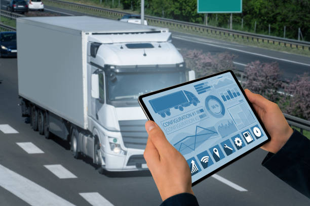 Manager with a digital tablet on the background of truck. Fleet management