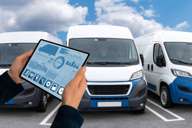 Manager with a digital tablet on the background of vans. Fleet management