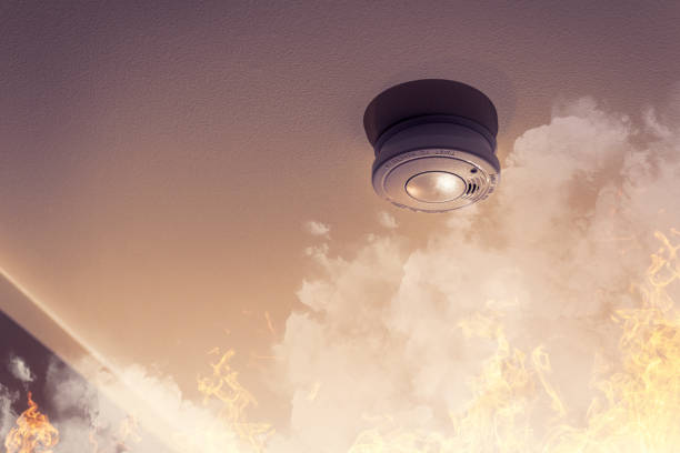 home safety - smoke detector on ceiling detecting house fire